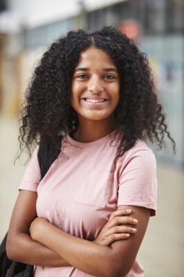 portrait-of-female-student-standing-in-college-PTK57Z8.jpg